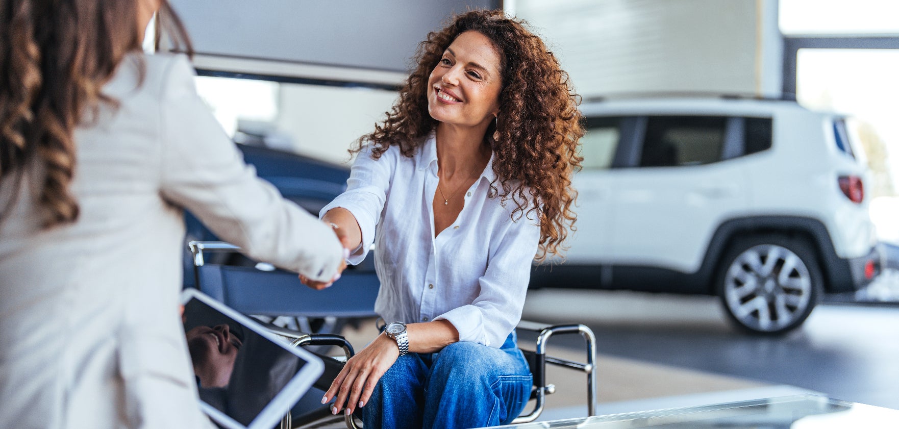 Happy customer shakes hands with a sales representative