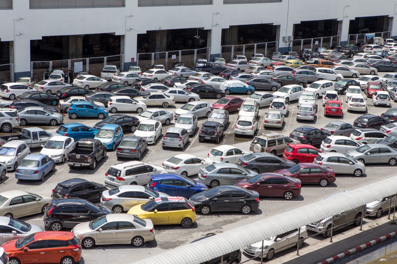An overhead view of a large used car lot.