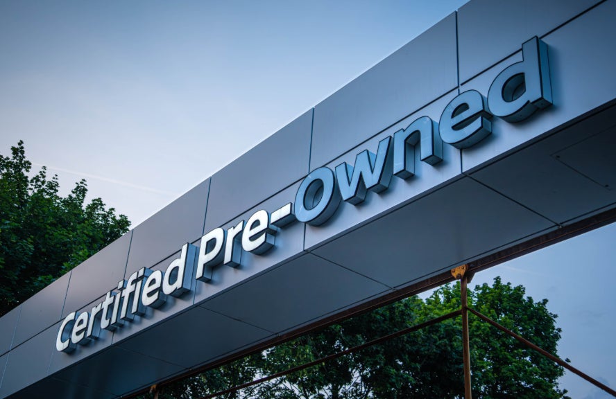 A certified pre-owned vehicle dealership sign.